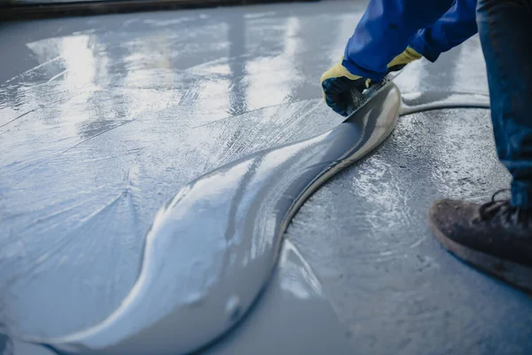 depositphotos 441118524 stock photo worker applies gray epoxy resin
