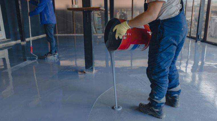 man pouring epoxy on floor millersburg pa (1)